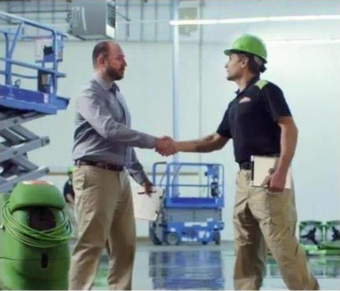 Man shaking hands with a SERVPRO tech