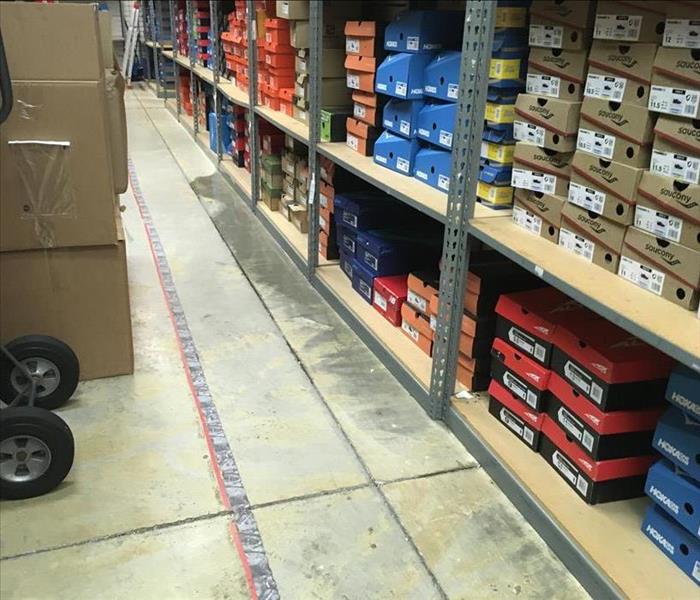 shoe boxes stacked on shelving in storeroom
