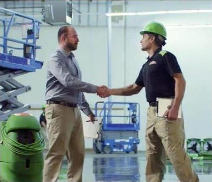 Man shaking hands with a SERVPRO tech